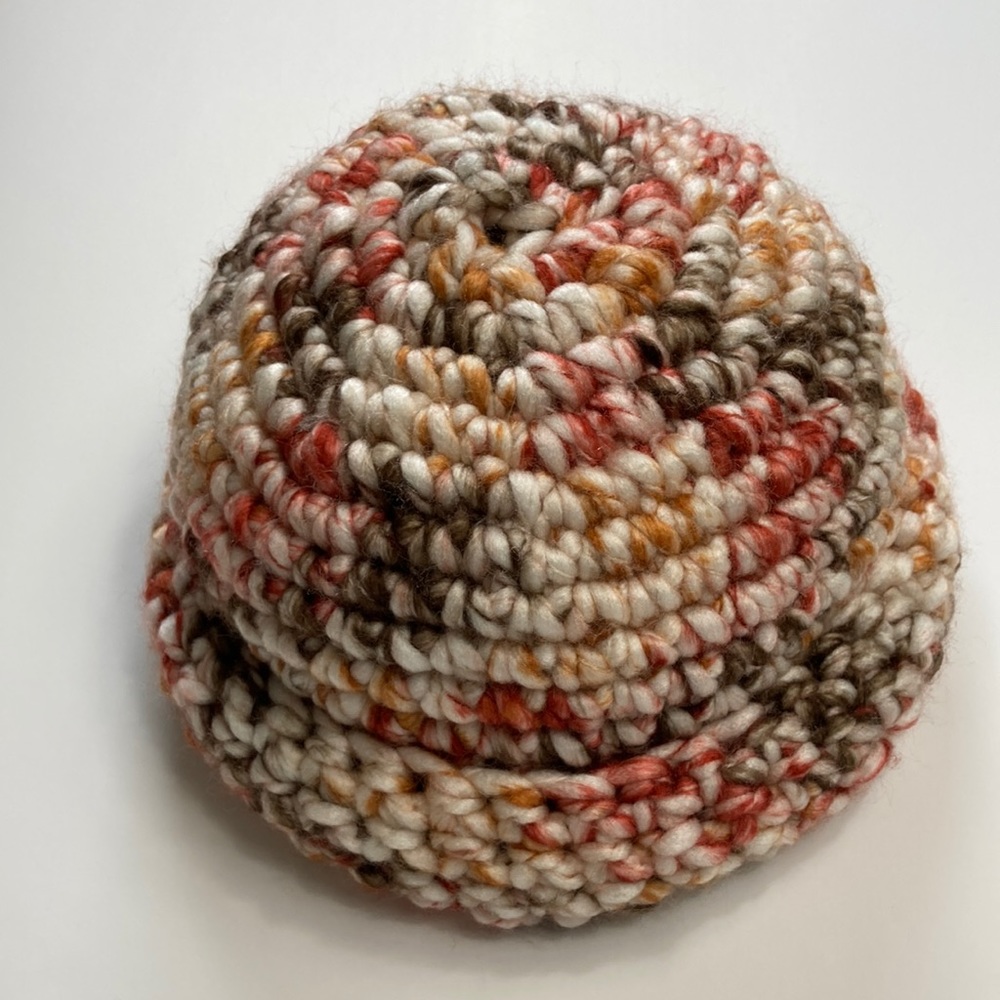 Hand made crocheted beanie NWOT. Multi colored ( red, orange, white) stretchy!!